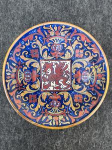 Majolica plate decorated with luster in the third firing with stylized plant motifs, vases with fruit, and a griffin in the center. Signature Prof. A. Santarelli, Gualdo Tadino.