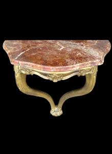 Gilded wood wall console with rocaille motifs and marble top. Art Nouveau period.