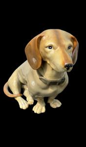 Polychrome porcelain dachshund figure.