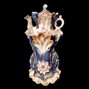 Porcelain teapot warmer with gold highlights, floral decoration, and raised vegetal and floral motifs. France.