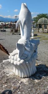 Dolphin and fish fountain on marble waves
