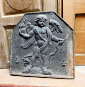 p137  piastra da camino in ghisa con raffigurato Cupido, cm 61 x h 63